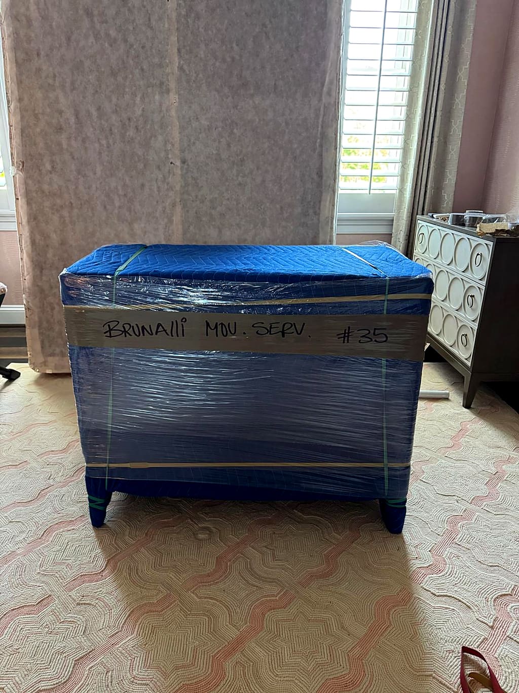 Wrapped bench with a handwritten Brunalli label and number
