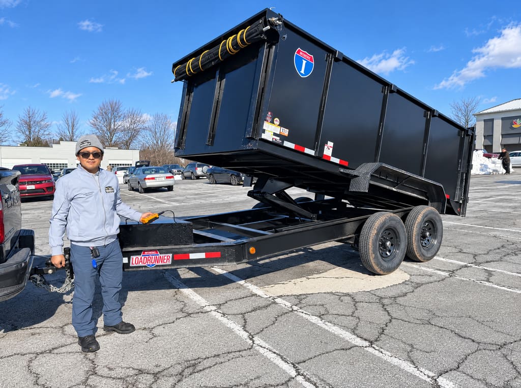 Luis with the black dump trailer bed raised