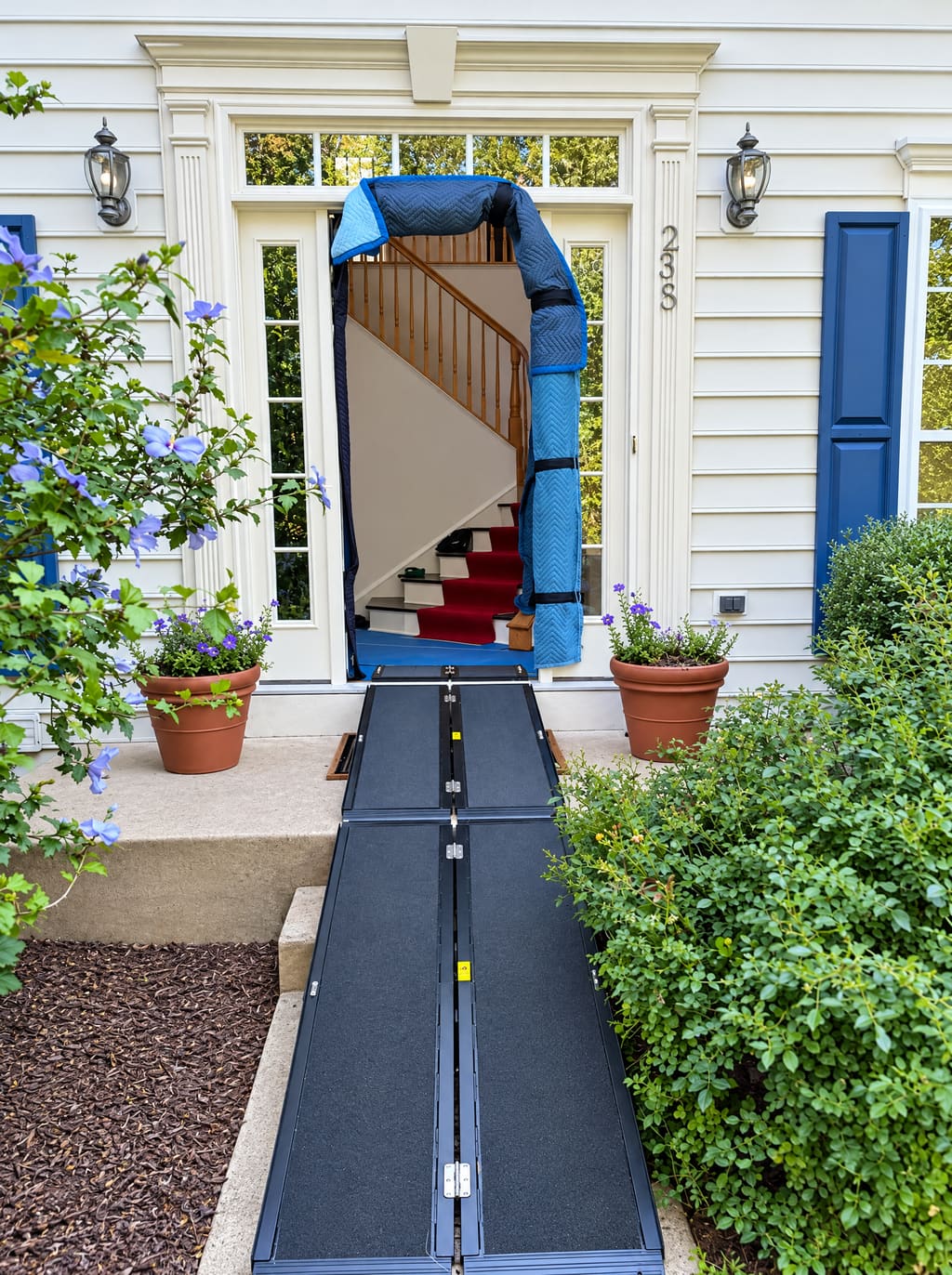 Front door protected with padding and a ramp before a local move