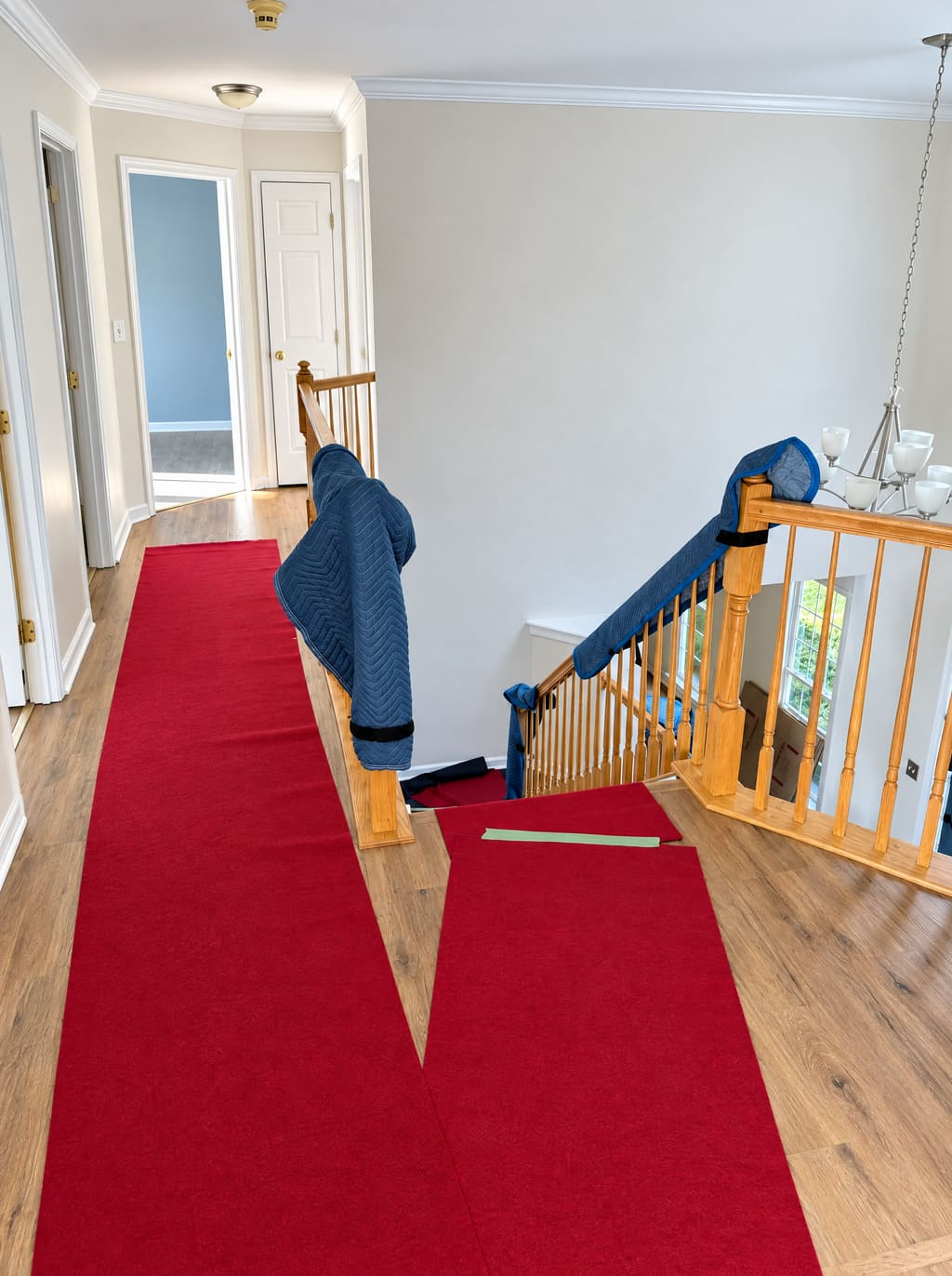 Upstairs hallway covered with a red runner