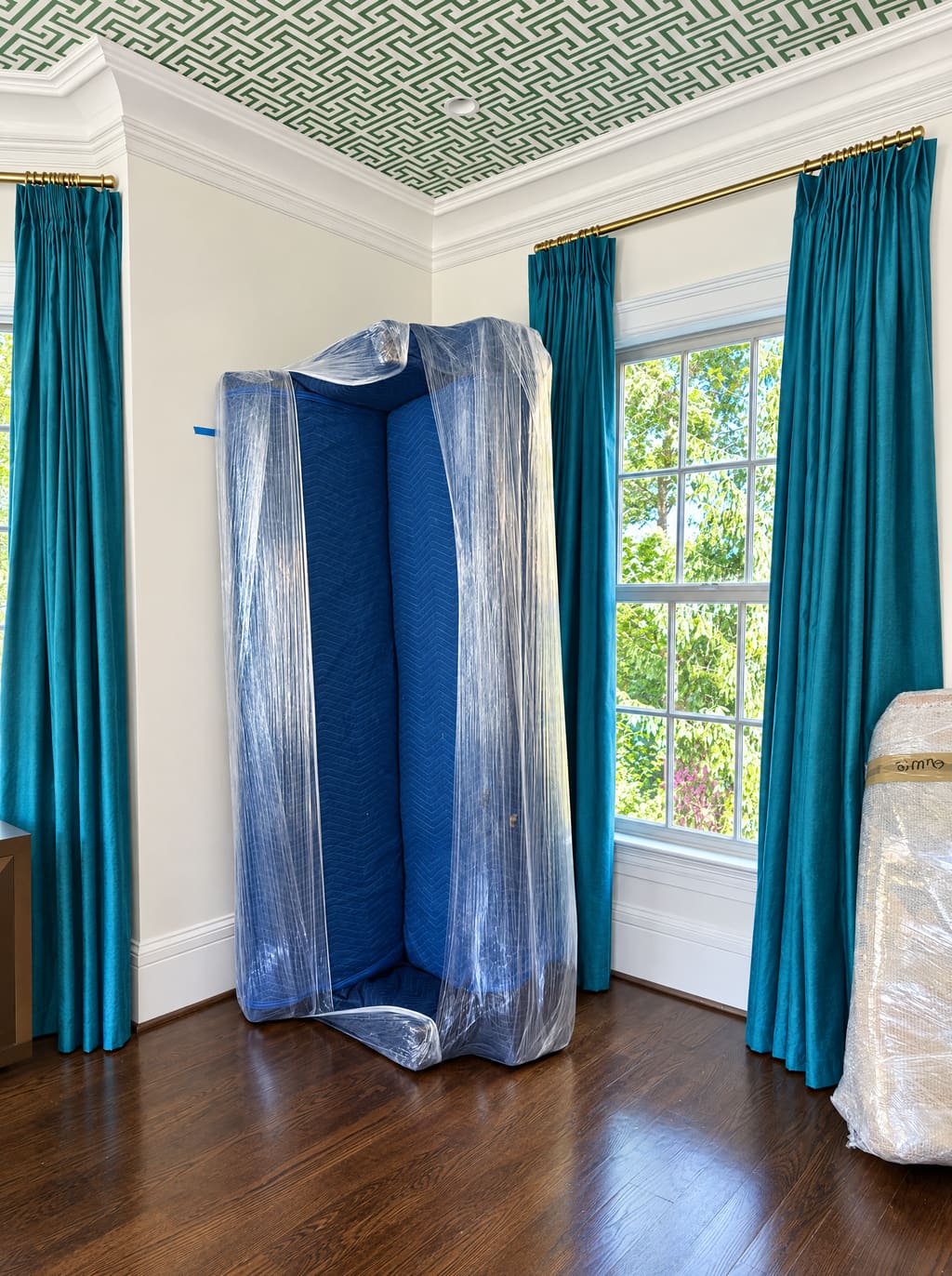 Tall wardrobe wrapped in blankets and stretch wrap